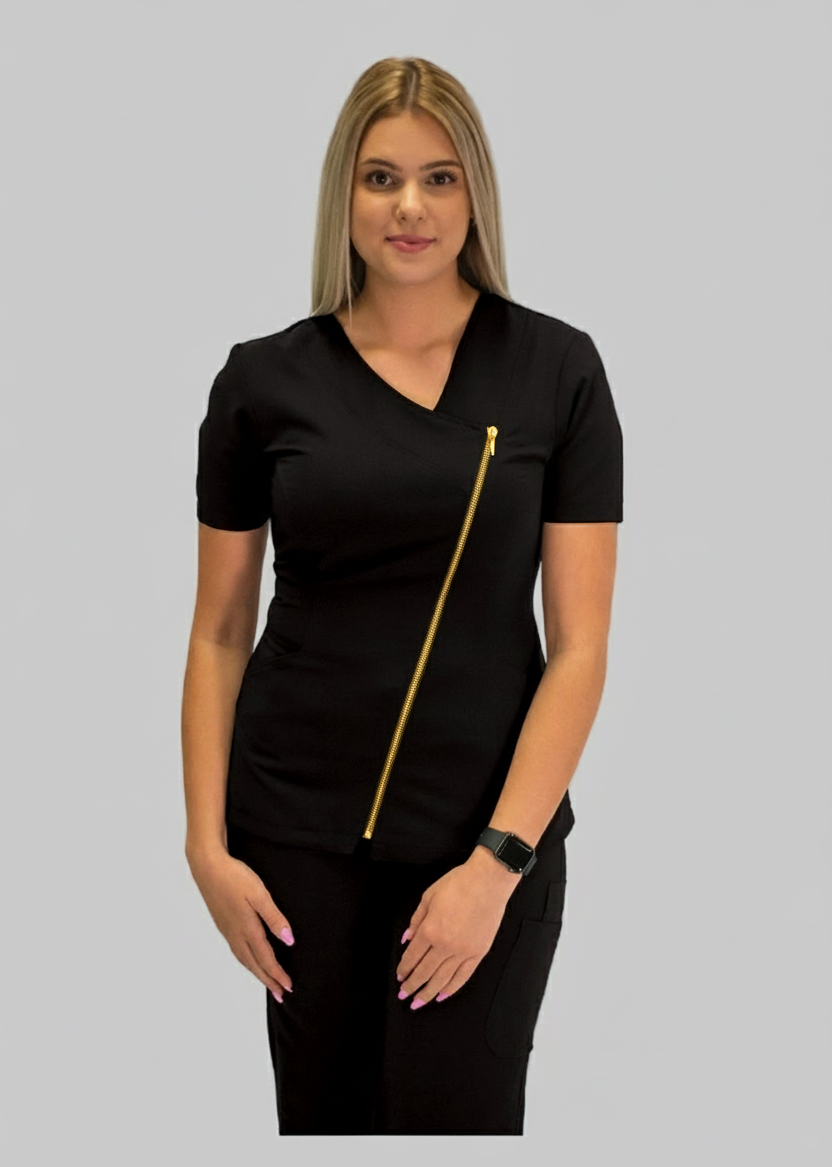 Woman wearing a black outfit with a gold zipper on a gray background