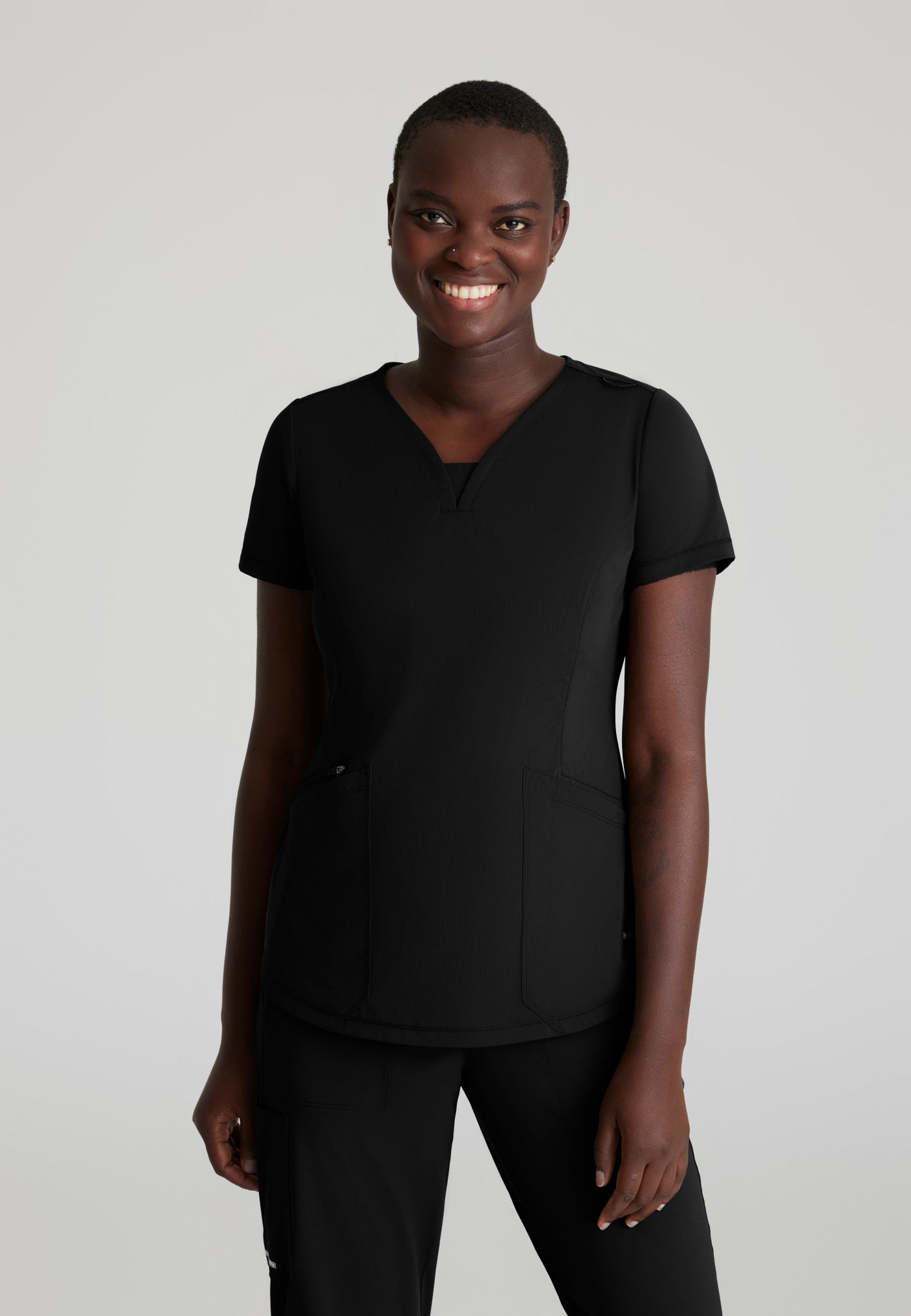 SKT220 Skechers Slip-Ins scrub top in Black. three pockets. stretchable fabric. front image