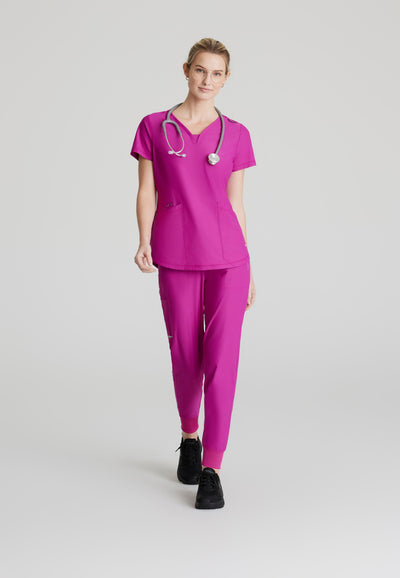 SKT220 Skechers Slip-Ins scrub top in deep magenta. three pockets. stretchable fabric. full body image