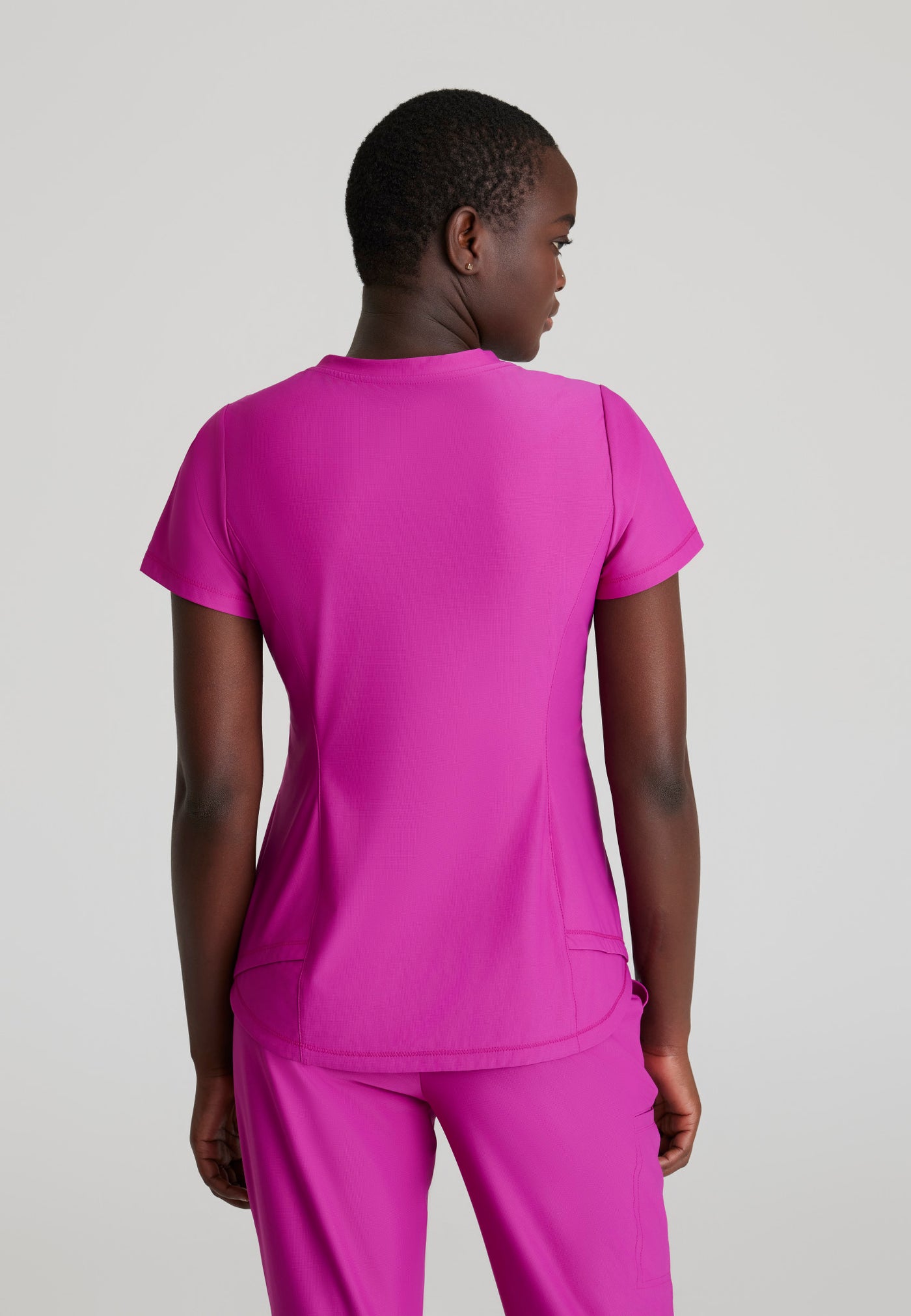 SKT221 Skechers Slip-Ins scrub top in deep magenta. tuckable. one top pocket. stretchable fabric. figs tops. back image