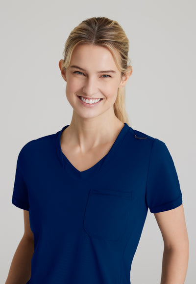 SKT221 Skechers Slip-Ins scrub top in navy. tuckable. one top pocket. women's. stretchable fabric. close up image